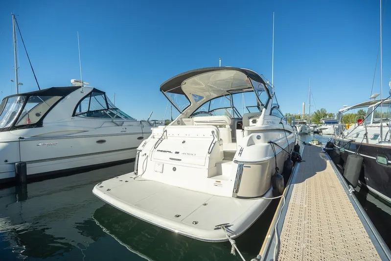  Yacht Photos Pics 2009 Regal Commodore 4060 yacht docked at marina under clear blue sky.