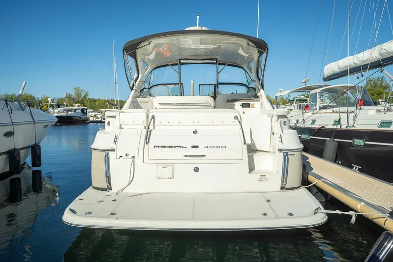  Yacht Photos Pics 2009 Regal Commodore 4060 yacht docked at marina, clear blue sky background.