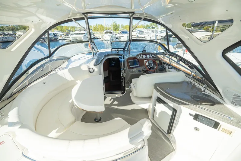  Yacht Photos Pics 2009 Regal Commodore 4060 yacht interior with seating, helm, and kitchenette at marina.