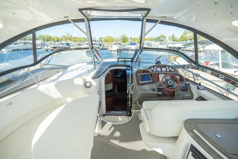  Yacht Photos Pics Interior of 2009 Regal Commodore 4060 yacht with helm, seating, and marina view.