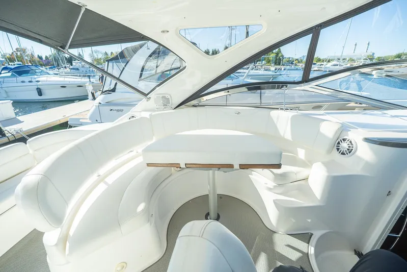  Yacht Photos Pics Luxurious 2009 Regal Commodore 4060 yacht interior with white seating and table in marina setting.