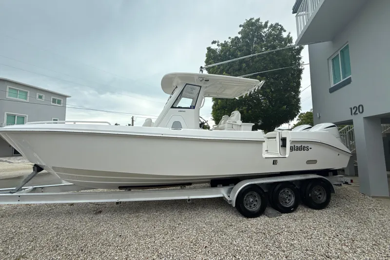  Yacht Photos Pics 2016 Everglades 295 Center Console boat on trailer, parked outdoors.