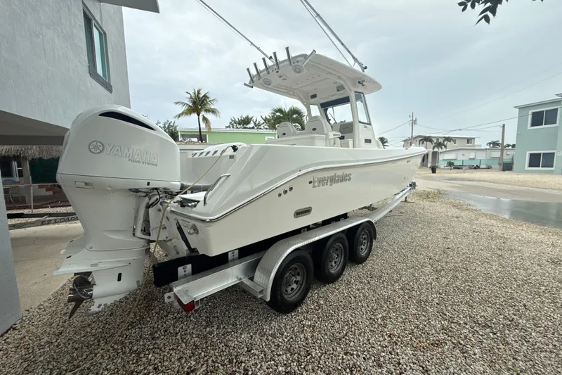  Yacht Photos Pics 2016 Everglades 295 Center Console boat on trailer with Yamaha engine, parked outdoors.