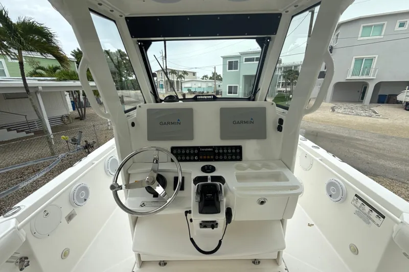  Yacht Photos Pics 2016 Everglades 295 Center Console boat helm with Garmin navigation system and steering wheel.