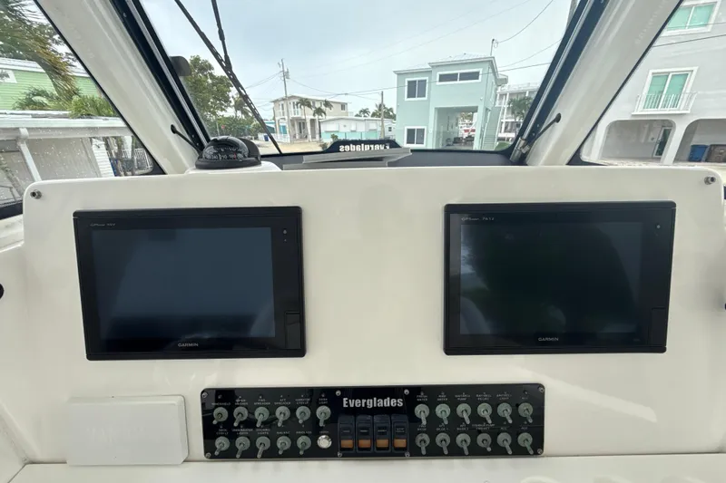  Yacht Photos Pics Control panel of 2016 Everglades 295 Center Console with dual Garmin screens and switches.