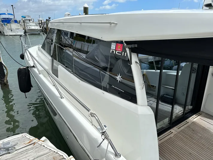 Andalucia Yacht Photos Pics 2017 Jeanneau NC 11 yacht docked at marina, side view.