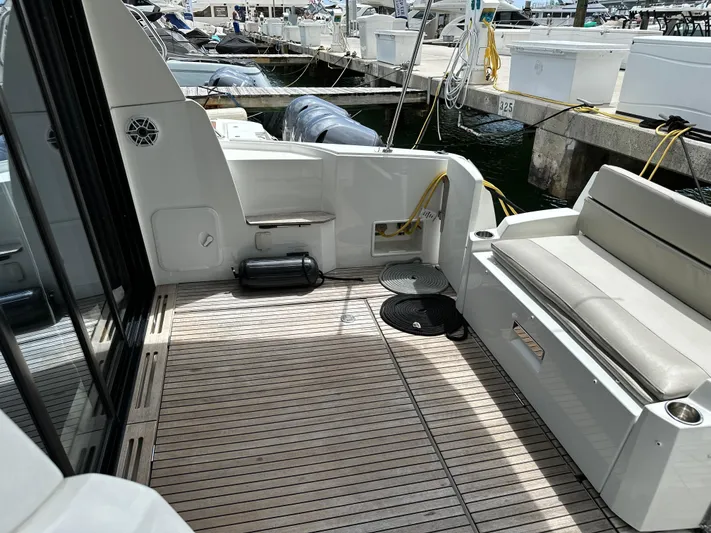 Andalucia Yacht Photos Pics 2017 Jeanneau NC 11 boat deck with seating, docked at marina.