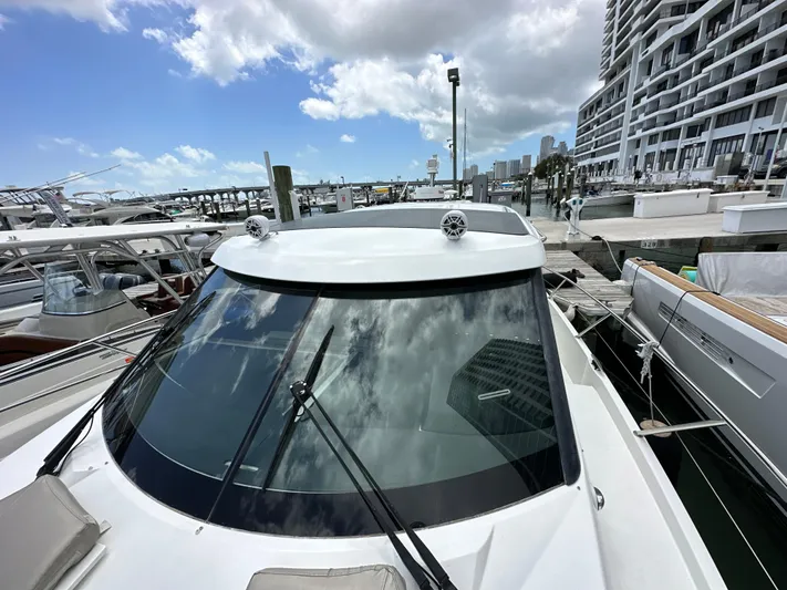 Andalucia Yacht Photos Pics 2017 Jeanneau NC 11 boat docked at a marina under a partly cloudy sky.