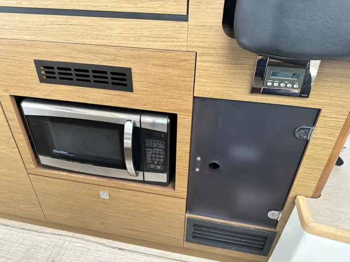 Andalucia Yacht Photos Pics Microwave and control panel in 2017 Jeanneau NC 11 boat interior.