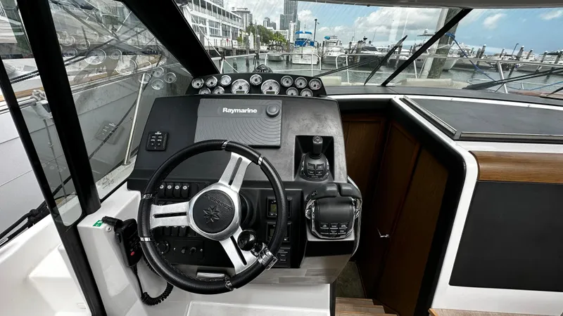 Andalucia Yacht Photos Pics 2017 Jeanneau NC 11 helm with steering wheel and navigation controls.