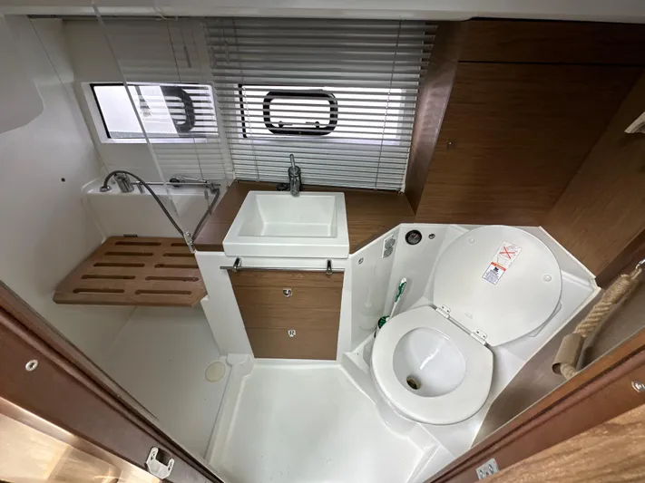 Andalucia Yacht Photos Pics Bathroom interior of 2017 Jeanneau NC 11 boat with sink and toilet.