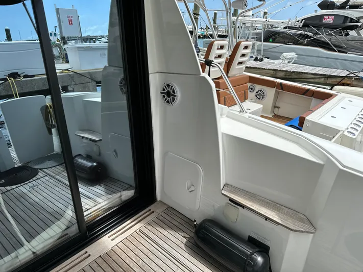 Andalucia Yacht Photos Pics 2017 Jeanneau NC 11 yacht deck with wooden flooring and seating area.