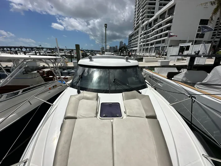 Andalucia Yacht Photos Pics 2017 Jeanneau NC 11 yacht docked at marina, featuring spacious sunbathing area.