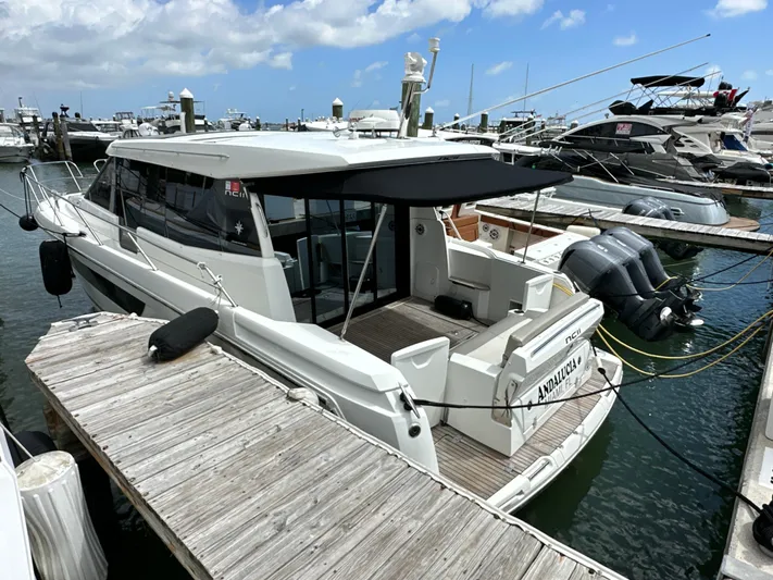 Andalucia Yacht Photos Pics 2017 Jeanneau NC 11 docked at marina, featuring sleek design and twin outboard engines.