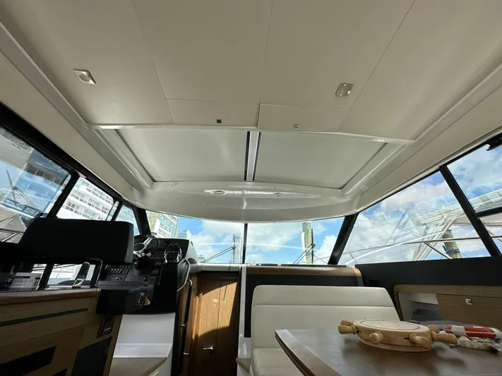 Andalucia Yacht Photos Pics Interior view of 2017 Jeanneau NC 11 yacht, featuring modern design and panoramic windows.