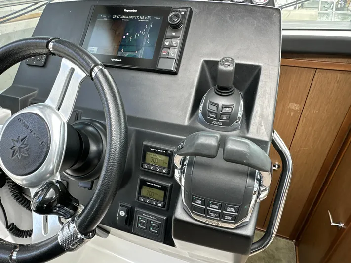 Andalucia Yacht Photos Pics Steering console of 2017 Jeanneau NC 11 boat with navigation controls and display.