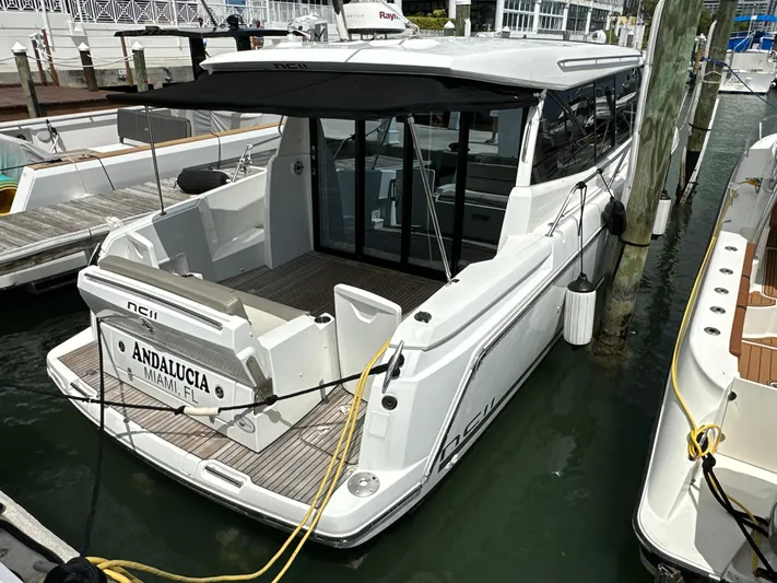 Andalucia Yacht Photos Pics 2017 Jeanneau NC 11 yacht docked, featuring sleek design and spacious deck area.