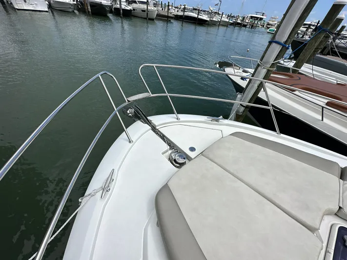 Andalucia Yacht Photos Pics Jeanneau NC 11 boat bow with cushioned seating, docked at marina, 2017 model.