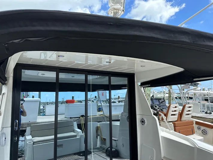 Andalucia Yacht Photos Pics 2017 Jeanneau NC 11 boat interior with sliding glass doors and seating area.