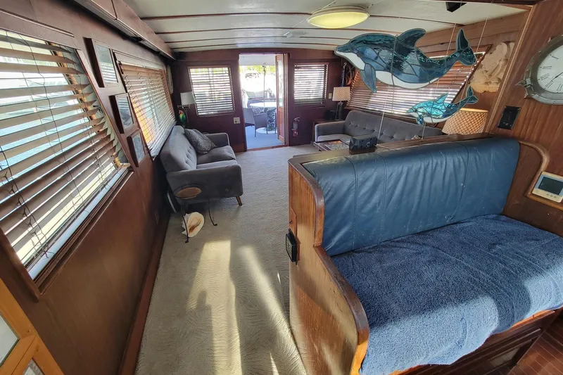 'elixir' Yacht Photos Pics Interior of 1982 Hatteras 56 Wide Body yacht with cozy seating and nautical decor.