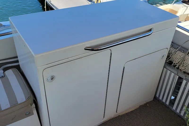 'elixir' Yacht Photos Pics Cabinet on 1982 Hatteras 56 Wide Body yacht deck, featuring sleek design and chrome handle.