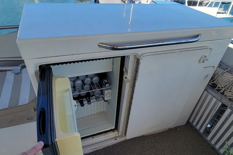 'elixir' Yacht Photos Pics Open mini fridge on 1982 Hatteras 56 Wide Body yacht, stocked with beverages.