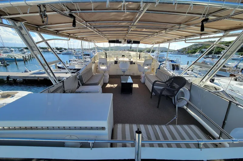 'elixir' Yacht Photos Pics Luxurious 1982 Hatteras 56 Wide Body yacht with spacious deck and marina view.