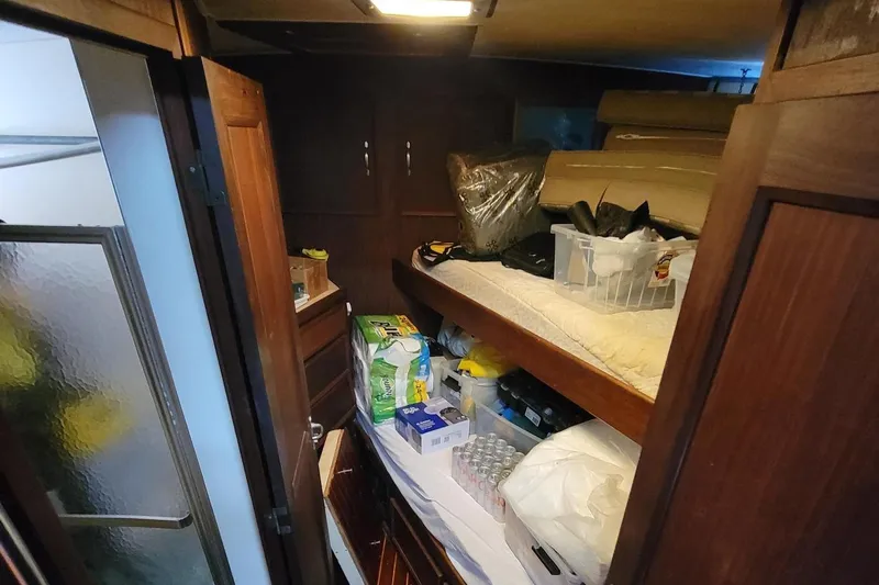 'elixir' Yacht Photos Pics Interior of 1982 Hatteras 56 Wide Body yacht with storage and bunk bed.