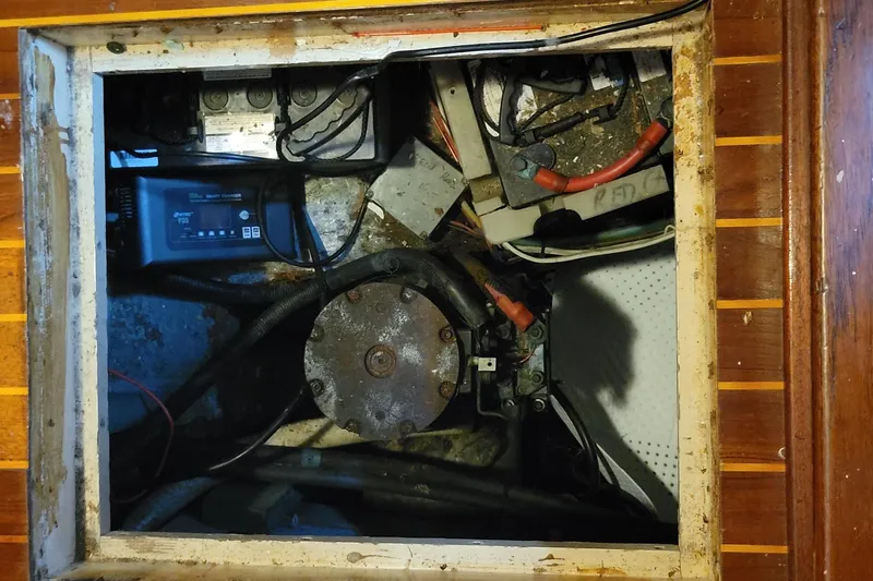 'elixir' Yacht Photos Pics Engine compartment of 1982 Hatteras 56 Wide Body yacht, showing mechanical components and wiring.