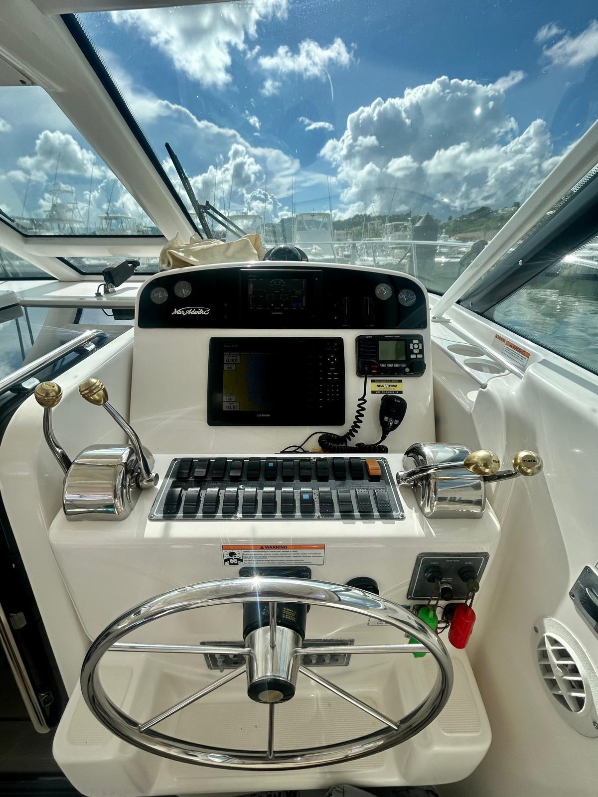 Helm of 2007 Open TIARA 36, featuring navigation controls and steering wheel under a sunny sky.