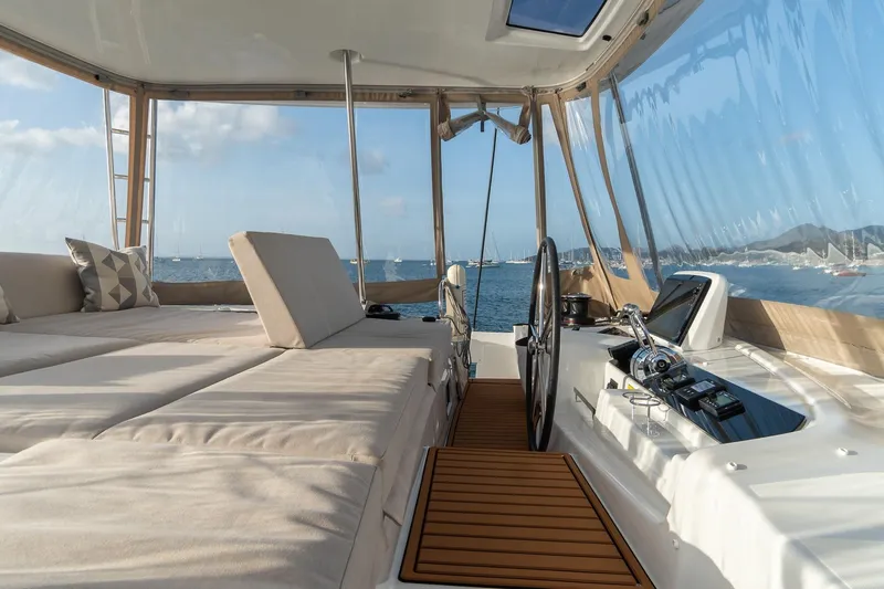 Altitude Adjustment Yacht Photos Pics Luxurious interior of 2022 Lagoon 46 catamaran with ocean view and modern helm.