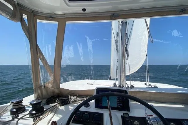Altitude Adjustment Yacht Photos Pics Cockpit view from 2022 Lagoon 46 catamaran sailing on open sea.