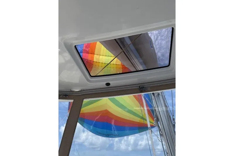 Altitude Adjustment Yacht Photos Pics View of colorful sail through Lagoon 46 catamaran skylight, 2022 model.
