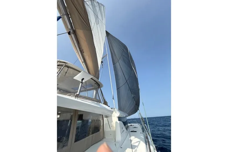 Altitude Adjustment Yacht Photos Pics 2022 Lagoon 46 sailing yacht with sails unfurled on open sea.