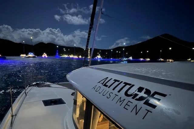 Altitude Adjustment Yacht Photos Pics Lagoon 46 catamaran "Altitude Adjustment" at night, illuminated boats in the background.