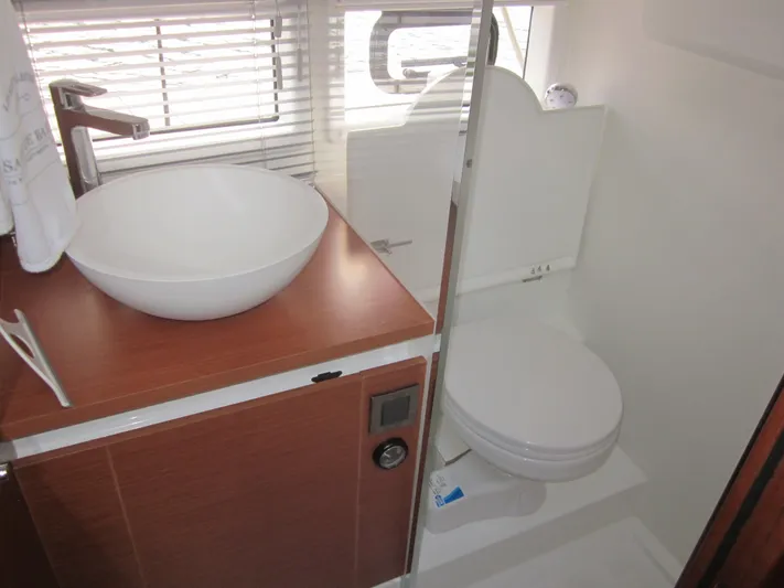  Yacht Photos Pics Bathroom interior of 2019 Jeanneau NC 33 yacht with modern sink and toilet.