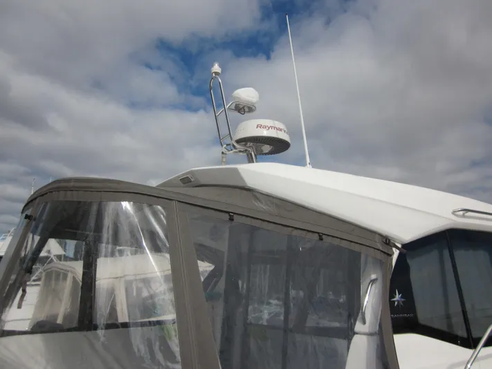  Yacht Photos Pics 2019 Jeanneau NC 33 boat with radar and canopy under cloudy sky.