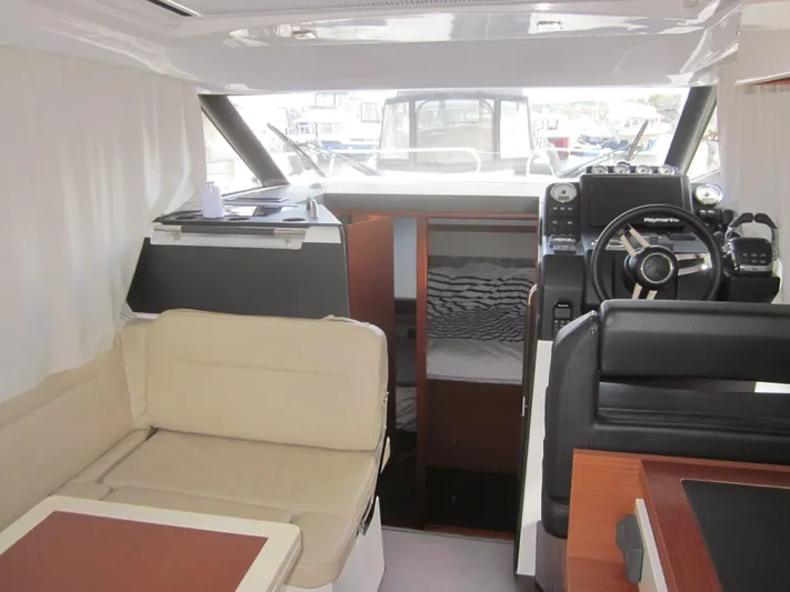 Yacht Photos Pics Interior of 2019 Jeanneau NC 33 boat with helm, seating, and cabin view.