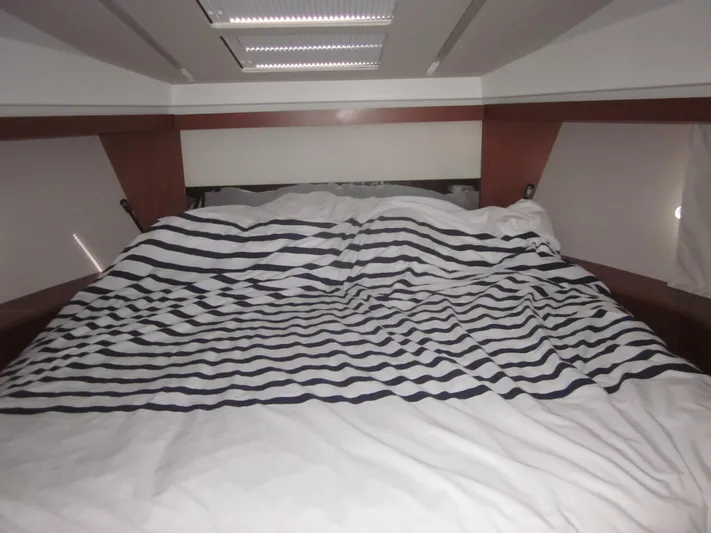  Yacht Photos Pics Interior cabin of 2019 Jeanneau NC 33 with striped bedding.