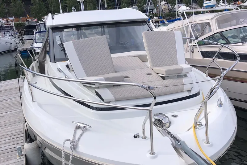  Yacht Photos Pics 2019 Jeanneau NC 33 boat docked, featuring a spacious sun deck with adjustable seating.