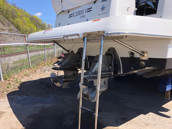  Yacht Photos Pics 2019 Jeanneau NC 33 boat stern with ladder and dual outboard motors.