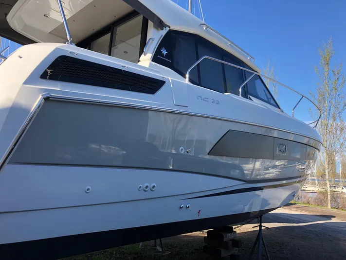  Yacht Photos Pics 2019 Jeanneau NC 33 boat on display, side view with sleek design and modern features.