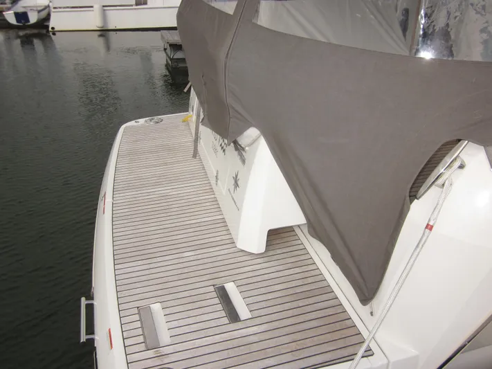  Yacht Photos Pics 2019 Jeanneau NC 33 boat with covered deck, docked in marina.