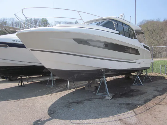  Yacht Photos Pics 2019 Jeanneau NC 33 boat on stands, displayed outdoors.