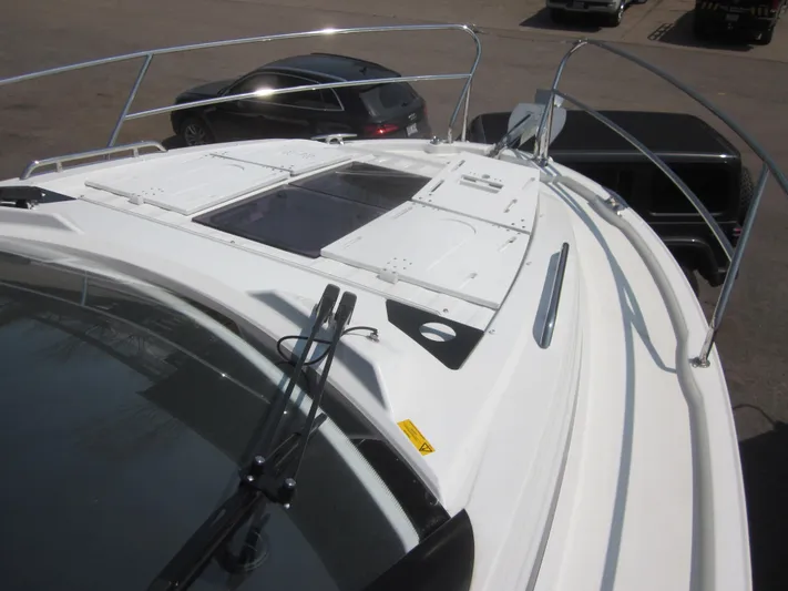  Yacht Photos Pics 2019 Jeanneau NC 33 boat deck with railing and hatch, parked in a lot.