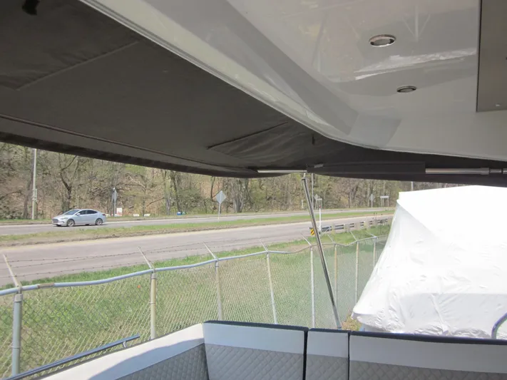  Yacht Photos Pics 2019 Jeanneau NC 33 boat interior with view of road and fence.
