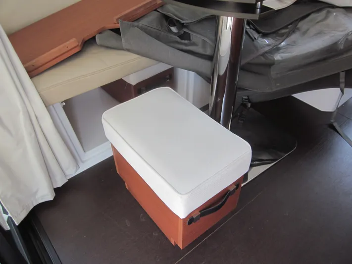  Yacht Photos Pics Interior of 2019 Jeanneau NC 33 boat with cushioned stool and table.