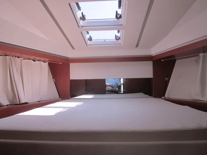  Yacht Photos Pics Luxurious cabin interior of 2019 Jeanneau NC 33 with skylights and curtains.