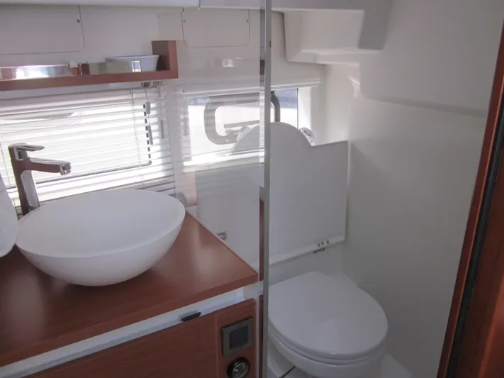  Yacht Photos Pics Modern bathroom interior of 2019 Jeanneau NC 33 yacht with sink and toilet.