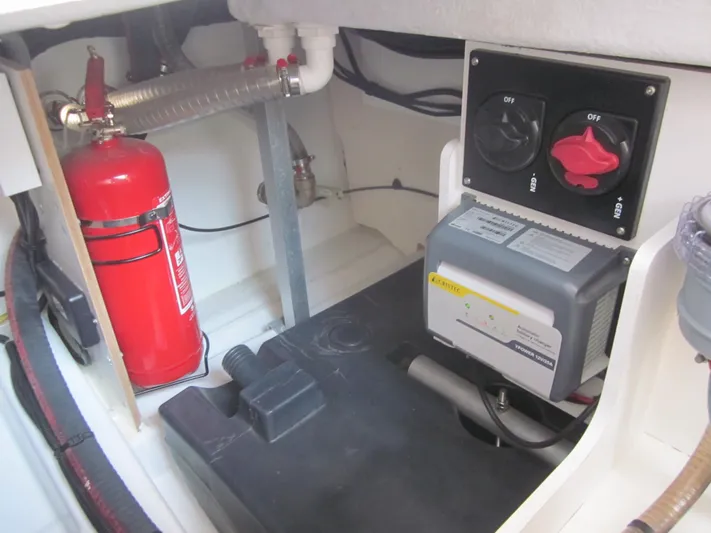  Yacht Photos Pics Engine compartment of 2019 Jeanneau NC 33 with fire extinguisher and control panel.